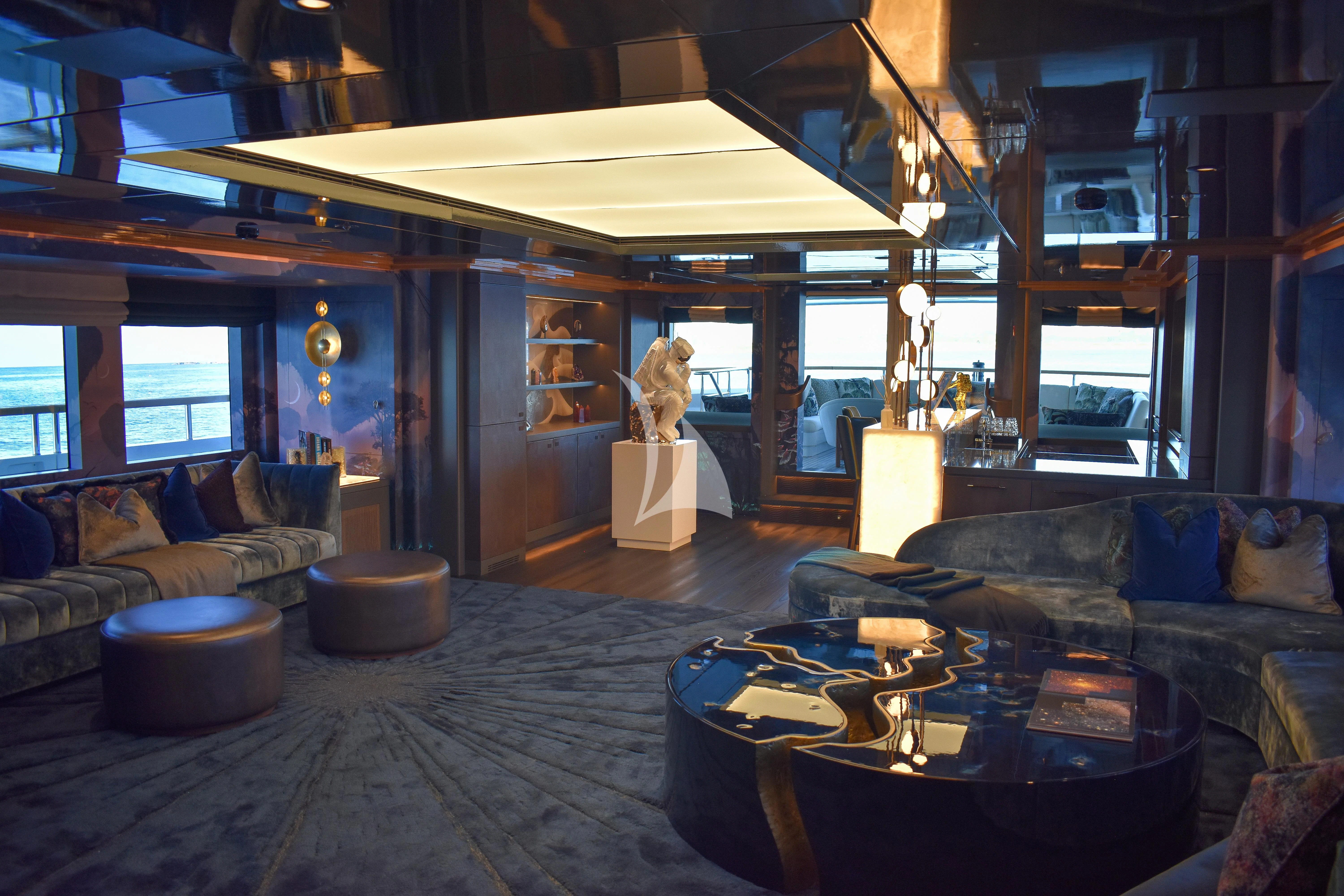 a room with a table and couches aboard GALAXY Yacht for Sale