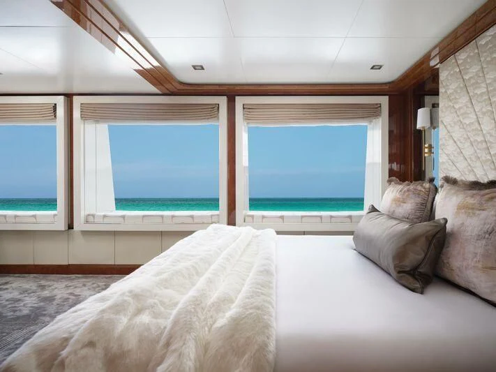 a bed with a window aboard GALAXY Yacht for Sale