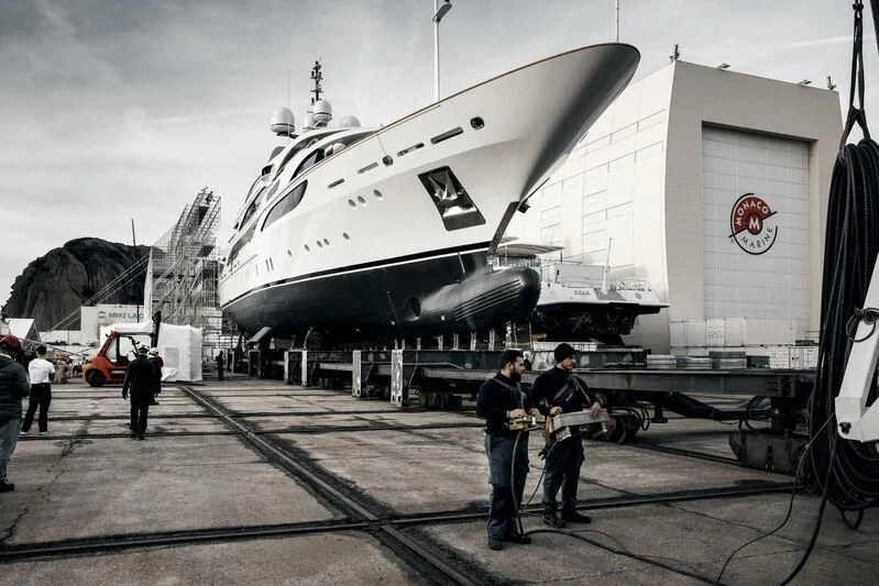 a group of people standing next to a large aircraft aboard GALAXY Yacht for Sale