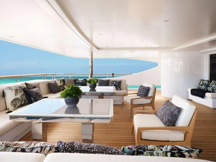 a living room with a large blue swimming pool aboard GALAXY Yacht for Sale
