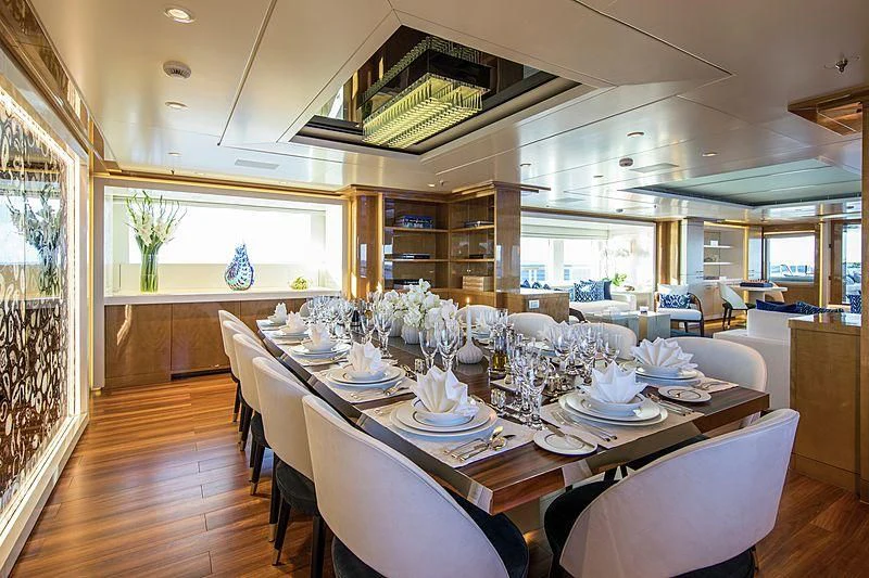 a dining room with a table set aboard GALAXY Yacht for Sale