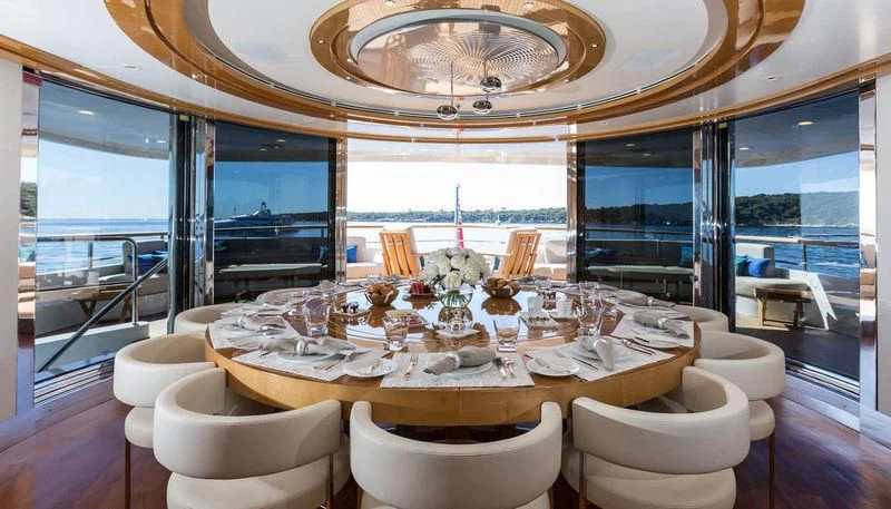 a dining room with a large chandelier aboard GALAXY Yacht for Sale