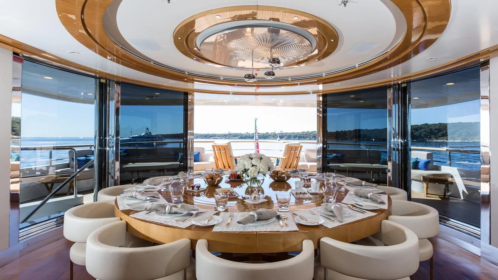 a dining room with a large chandelier aboard GALAXY Yacht for Sale