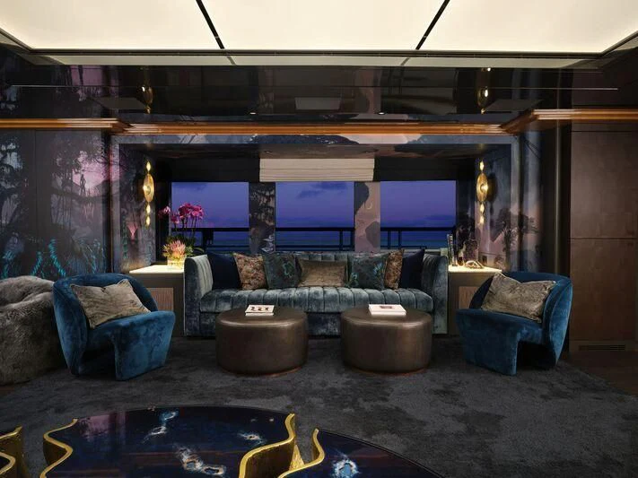 a living room with a large fireplace aboard GALAXY Yacht for Sale