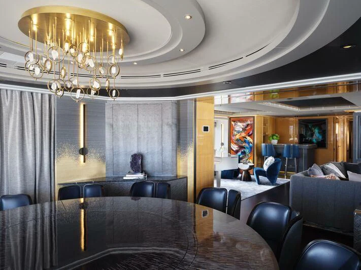 a large room with a chandelier and a table aboard GALAXY Yacht for Sale