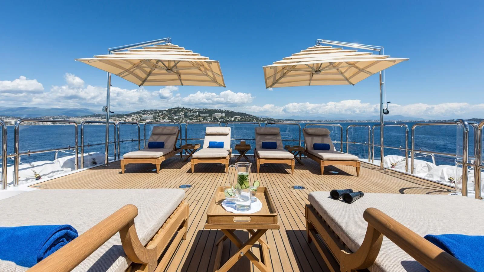 a deck with chairs and umbrellas aboard GALAXY Yacht for Sale