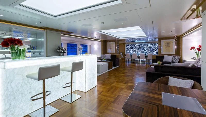 a large living room with a kitchen and dining area aboard GALAXY Yacht for Sale