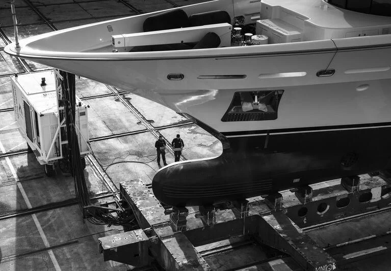 a couple of people standing next to a plane aboard GALAXY Yacht for Sale