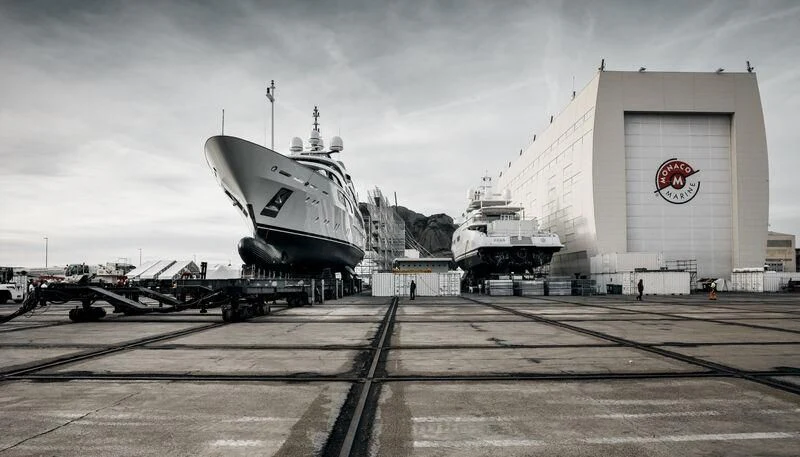 a large military plane parked next to a building aboard GALAXY Yacht for Sale
