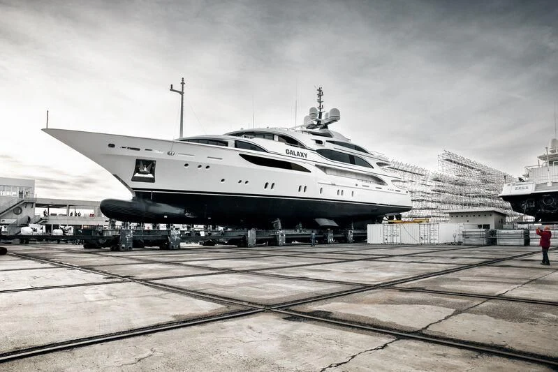a large airplane is parked at a loading dock aboard GALAXY Yacht for Sale