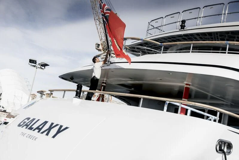 a boat with a flag on it aboard GALAXY Yacht for Sale