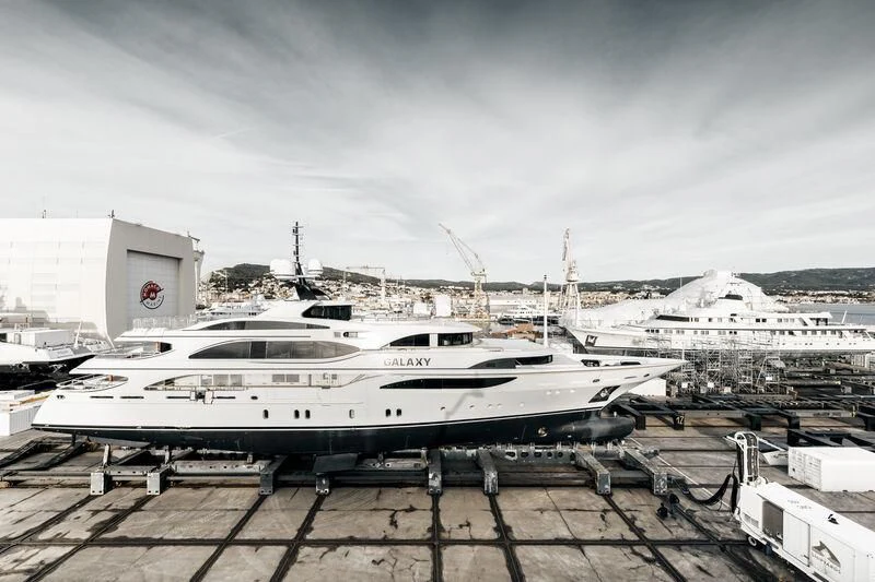 a white yacht in a harbor aboard GALAXY Yacht for Sale