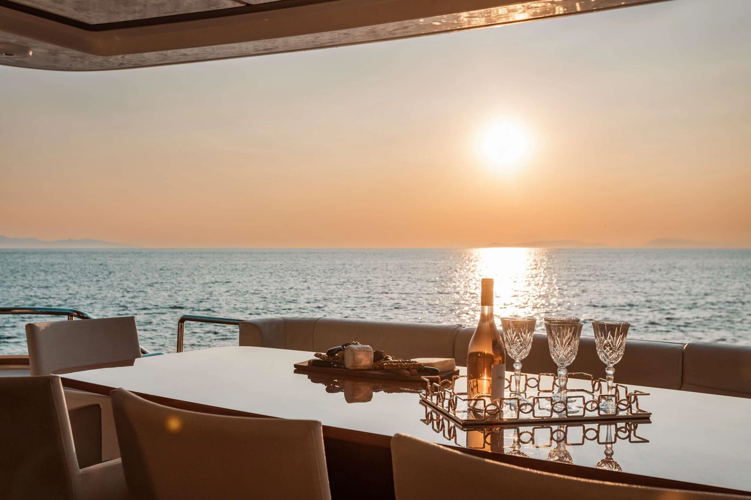 a table with wine glasses on it aboard ANLIA Yacht for Sale