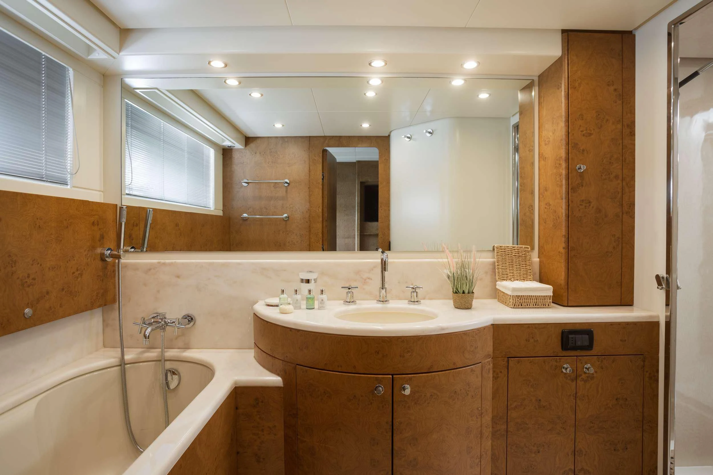 a bathroom with a tub sink and cabinets aboard ANLIA Yacht for Sale