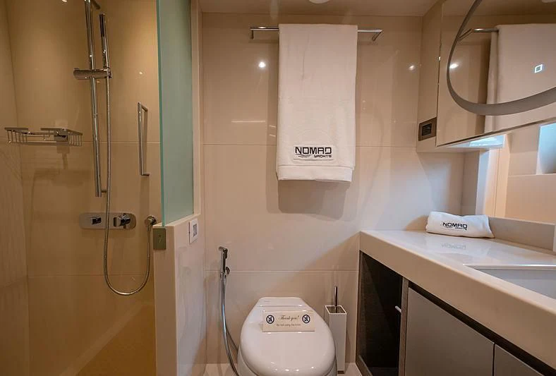 a bathroom with a toilet and a sink aboard DIGNITY Yacht for Sale