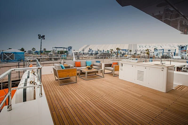 a deck with a view of a city and water aboard DIGNITY Yacht for Sale