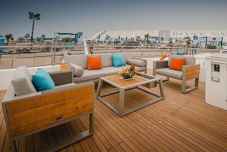 a room with a couch and a table and chairs aboard DIGNITY Yacht for Sale