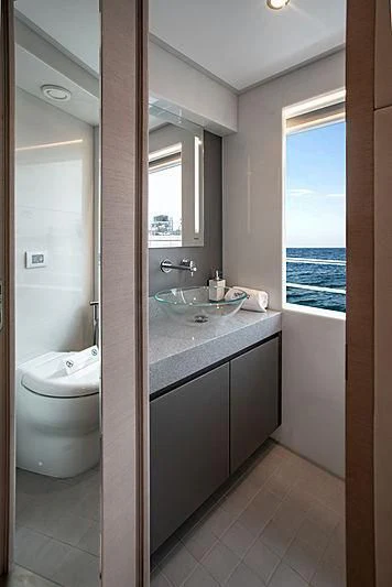 a bathroom with a sink and a toilet aboard DIGNITY Yacht for Sale