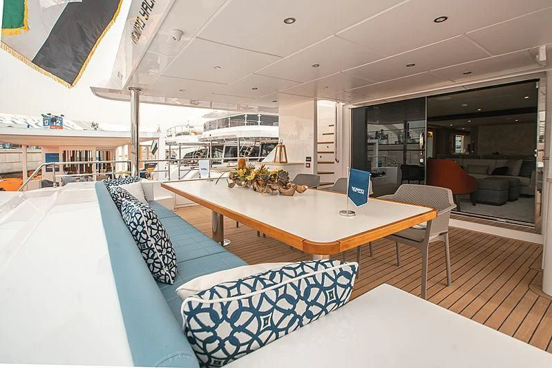 a room with a table chairs and a couch aboard DIGNITY Yacht for Sale