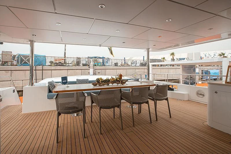 a large kitchen with a table and chairs aboard DIGNITY Yacht for Sale