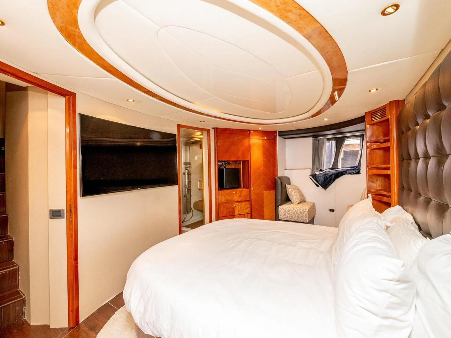 a bedroom with a bed and a mirror aboard NUEVA OLA Yacht for Sale