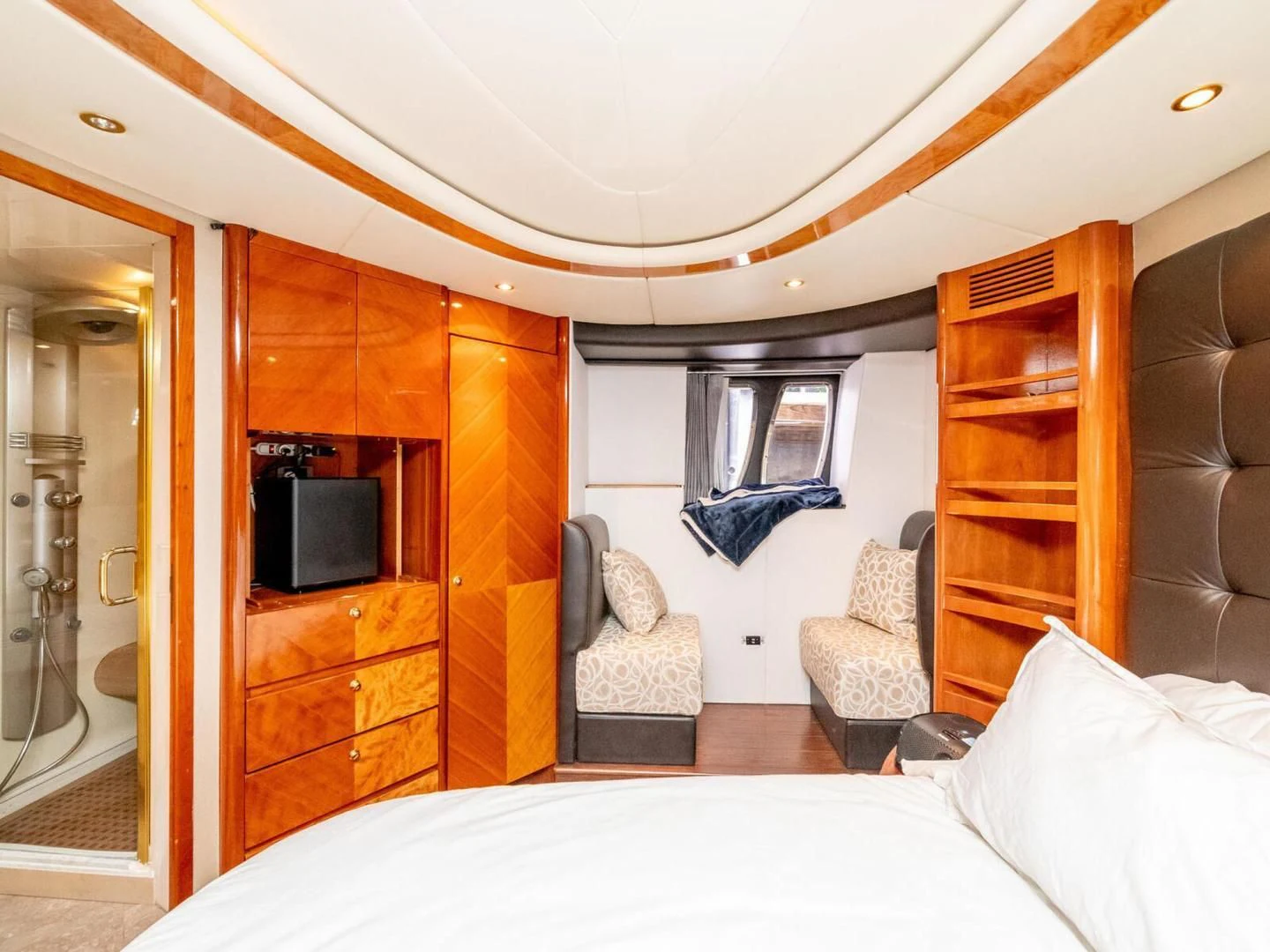 a bedroom with a bed and a tv aboard NUEVA OLA Yacht for Sale