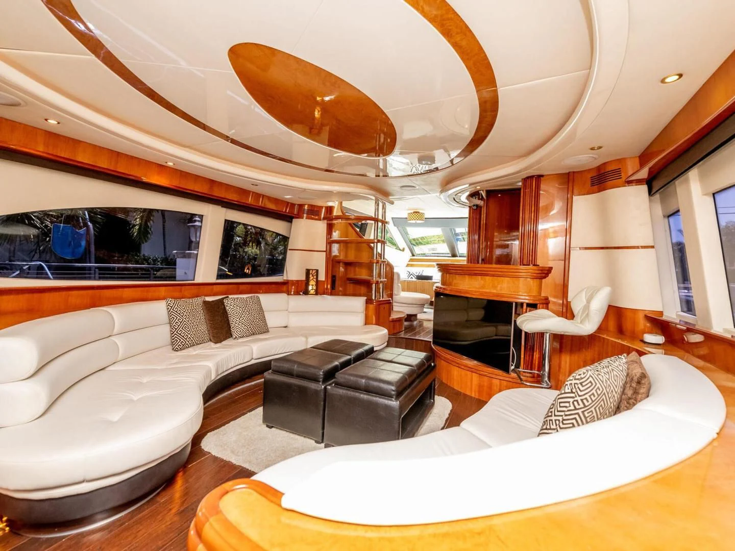 a large living room with a large mirror above the couch aboard NUEVA OLA Yacht for Sale