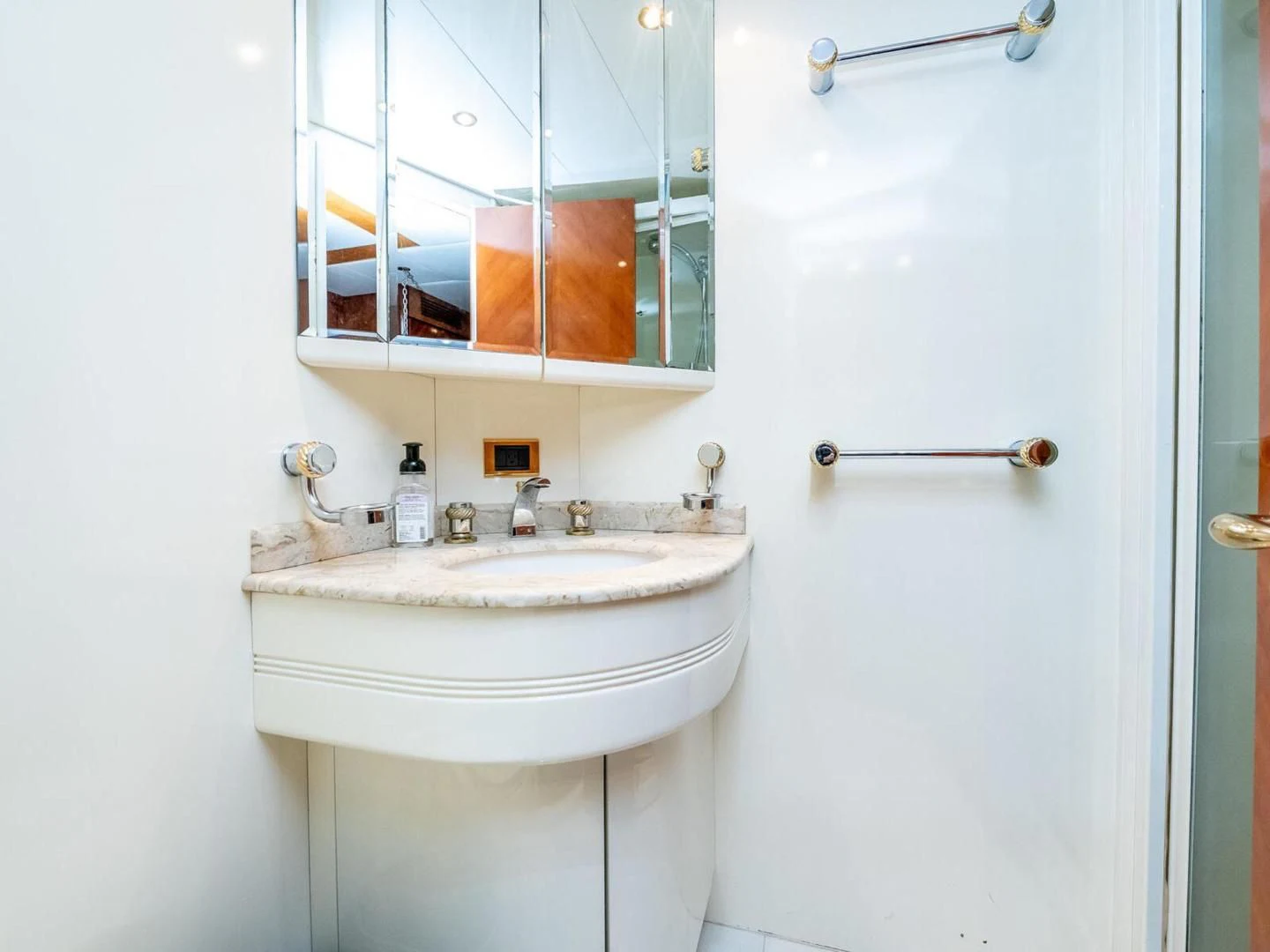 a bathroom with a sink and mirror aboard NUEVA OLA Yacht for Sale