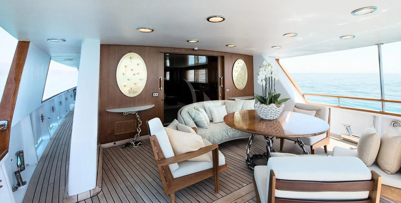 a room with a table chairs and a couch aboard SIRAHMY Yacht for Sale