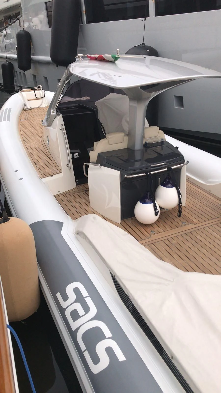 a white table with a black and white table and chairs aboard SIRAHMY Yacht for Sale