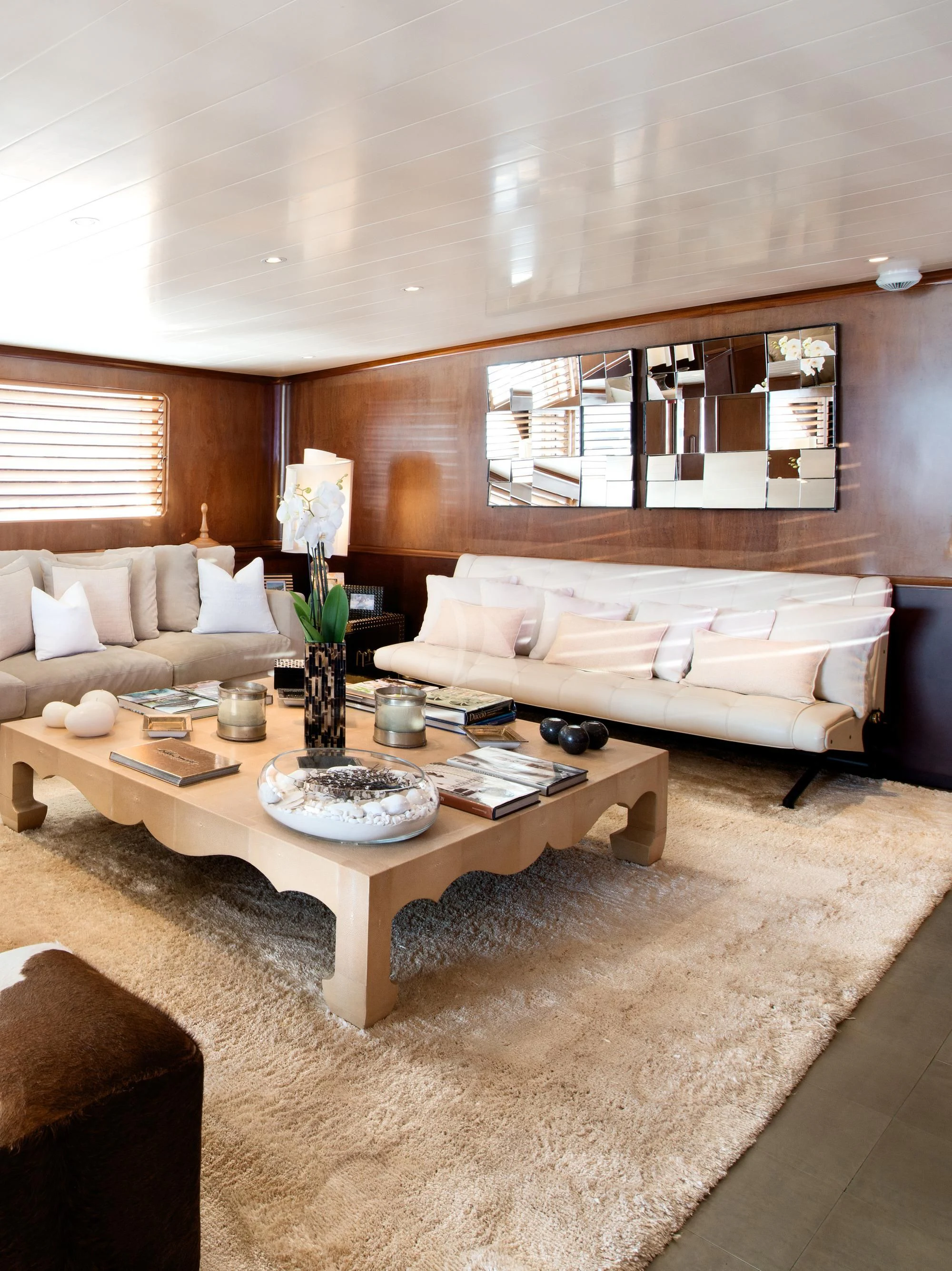 a living room with a couch and a coffee table aboard SIRAHMY Yacht for Sale