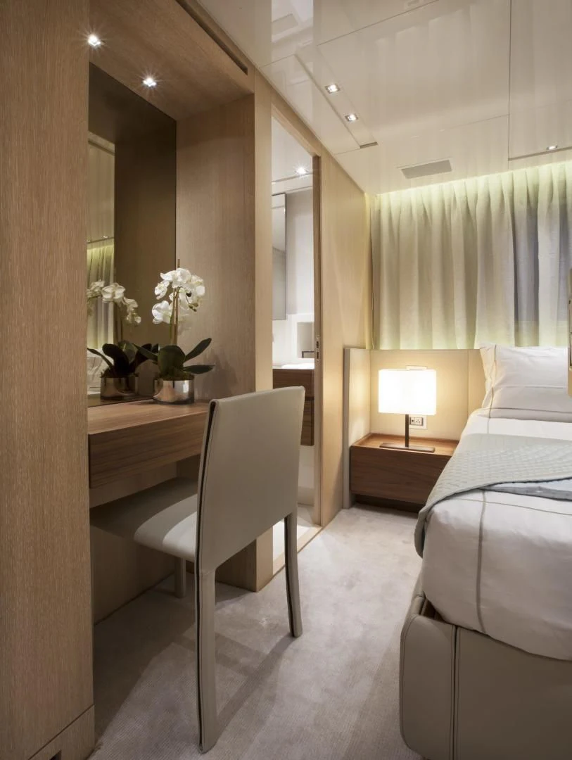 a hotel room with a bed and desk aboard GOLDEN YACHT Yacht for Sale