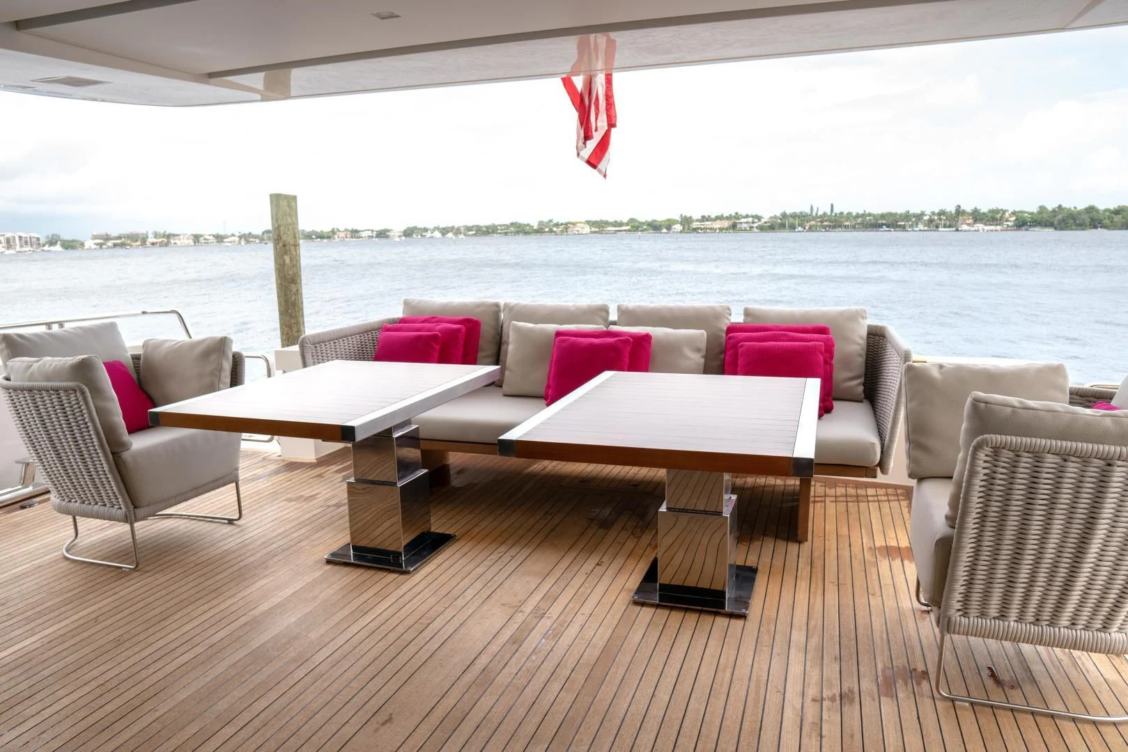 a large white couch and a table on a deck overlooking a body of water aboard GOLDEN YACHT Yacht for Sale