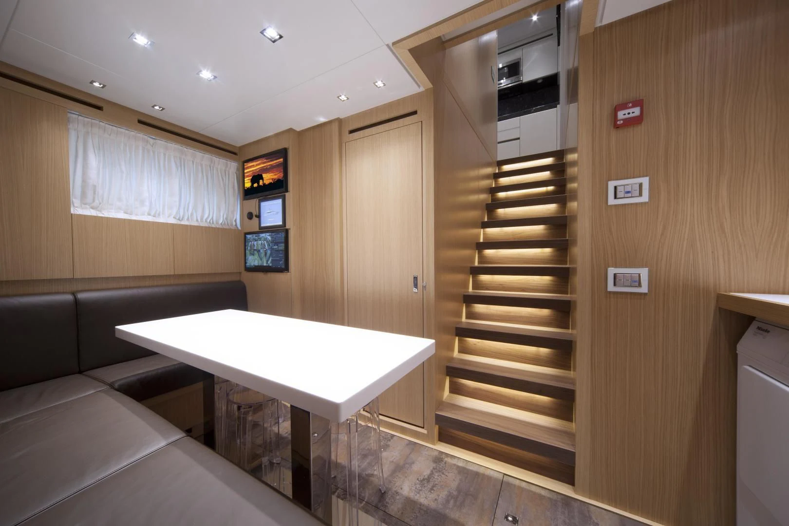 a room with a table and a couch aboard GOLDEN YACHT Yacht for Sale