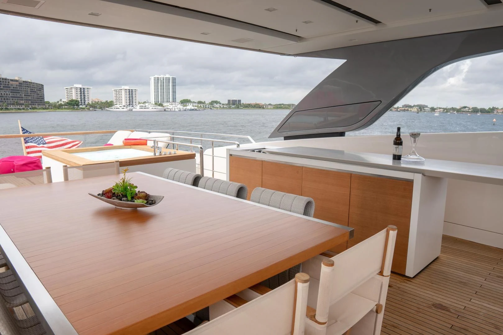 a table with a wine glass on it and a view of a city aboard GOLDEN YACHT Yacht for Sale