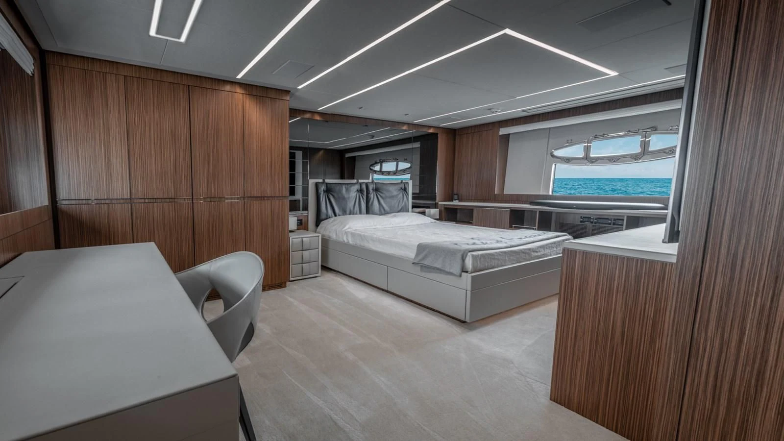 a room with a bed and a desk aboard NAAV Yacht for Sale