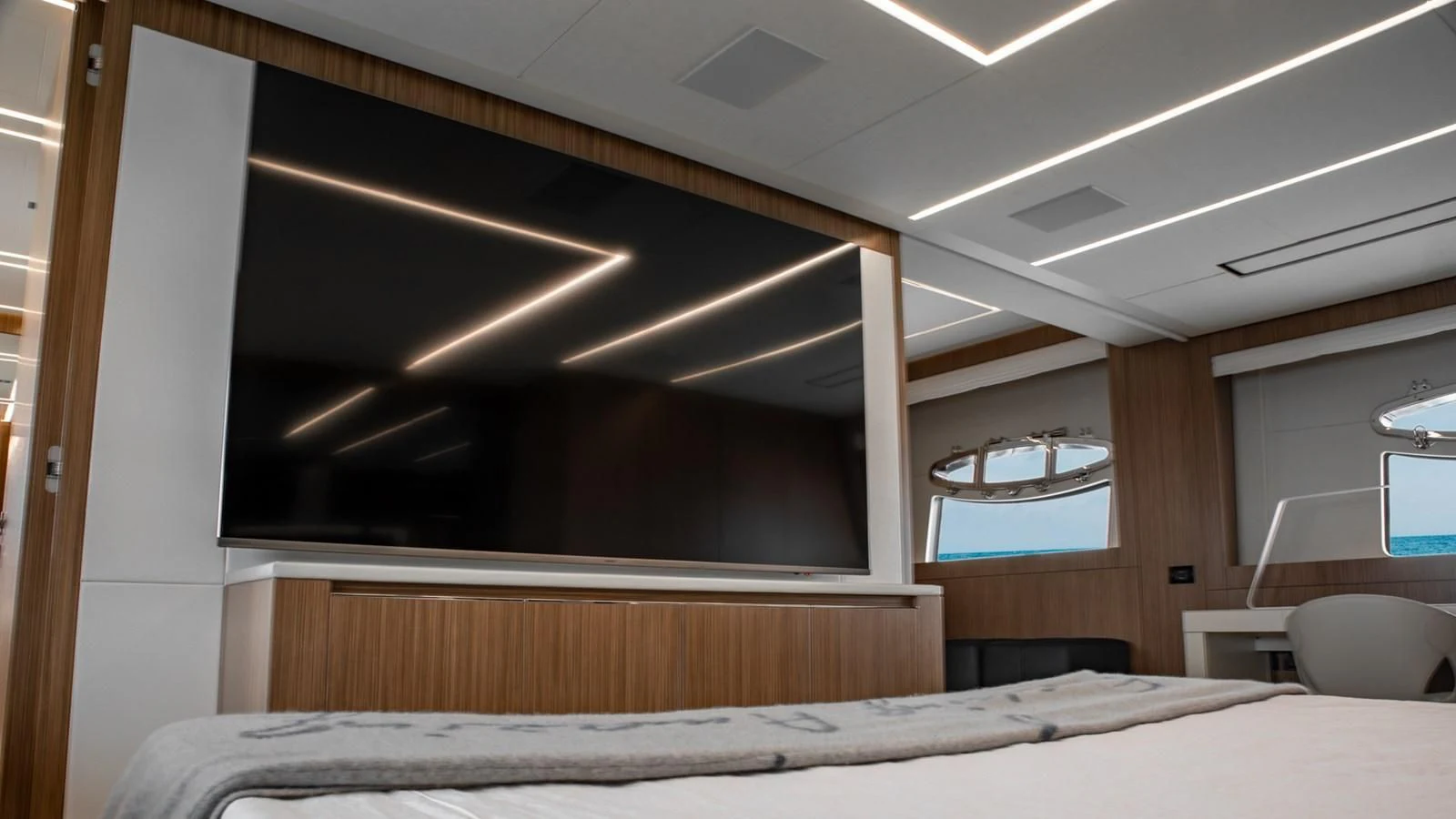 a room with a bed and a window aboard NAAV Yacht for Sale