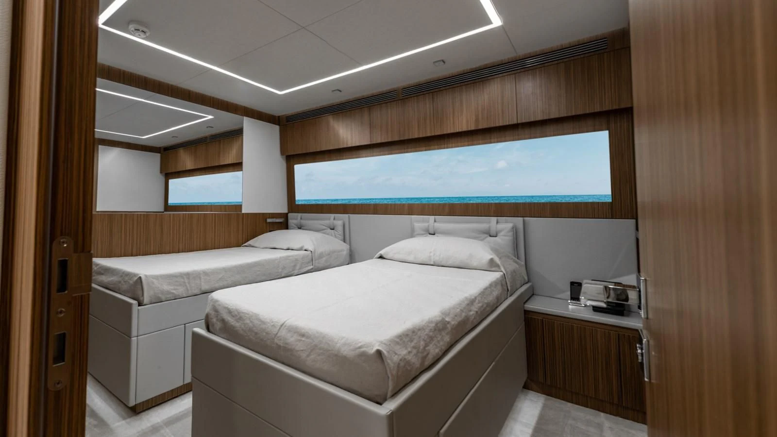 a room with two beds aboard NAAV Yacht for Sale