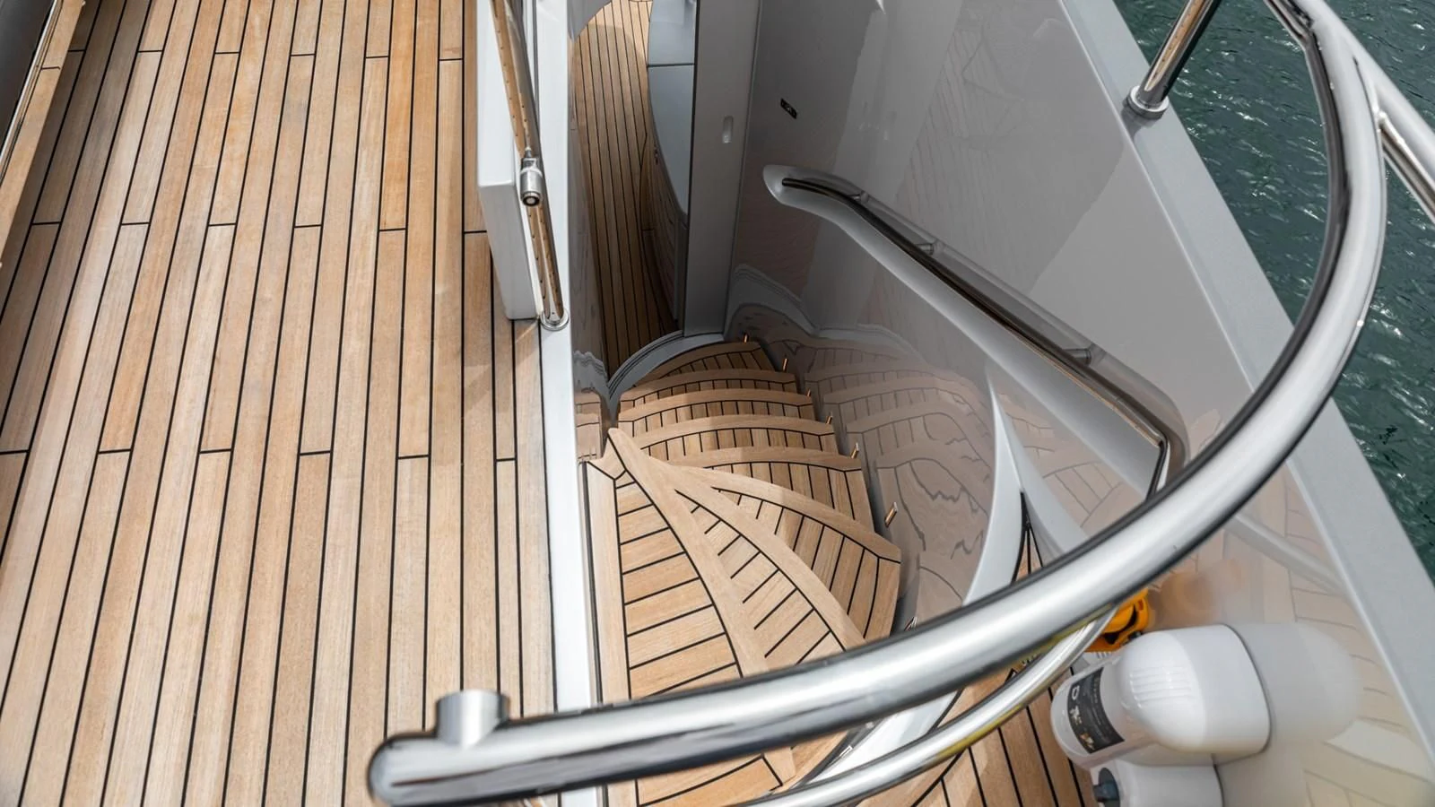 a white car on a wooden deck aboard NAAV Yacht for Sale