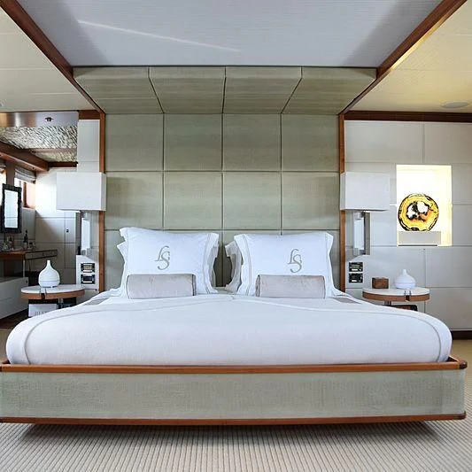 a bed with a white comforter aboard LIFE SAGA Yacht for Sale