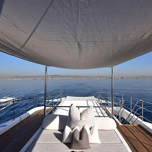 a lounge chair on a deck overlooking the ocean aboard LIFE SAGA Yacht for Sale