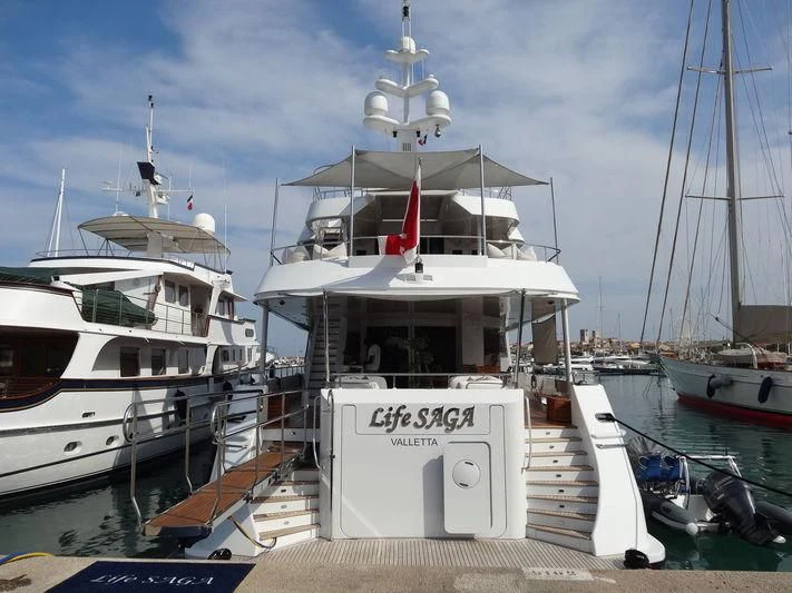 a boat docked at a pier aboard LIFE SAGA Yacht for Sale