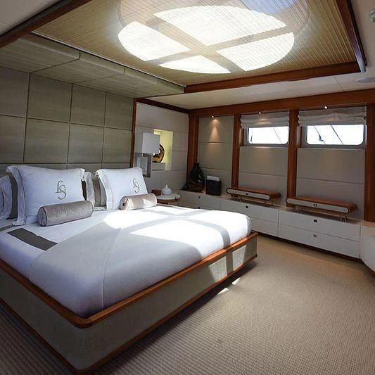 a bedroom with a bed and a ceiling fan aboard LIFE SAGA Yacht for Sale