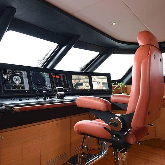 a person sitting in a chair in front of a computer aboard LIFE SAGA Yacht for Sale