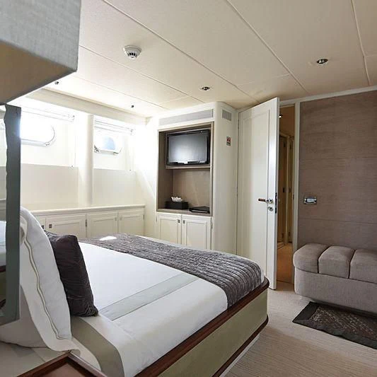 a bedroom with a bed and a couch aboard LIFE SAGA Yacht for Sale