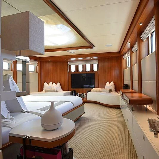 a room with a bed and a table aboard LIFE SAGA Yacht for Sale