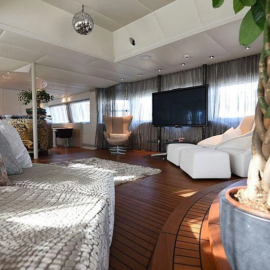 a living room with a large screen aboard LIFE SAGA Yacht for Sale