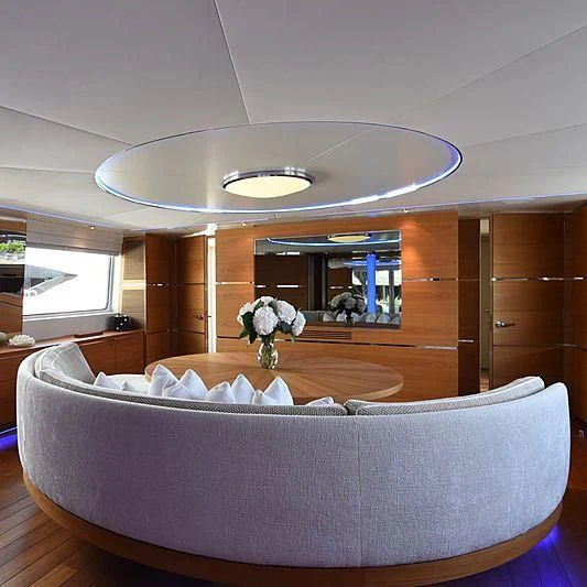 a large living room with a chandelier aboard LIFE SAGA Yacht for Sale