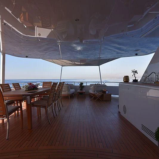 a room with a table and chairs aboard LIFE SAGA Yacht for Sale