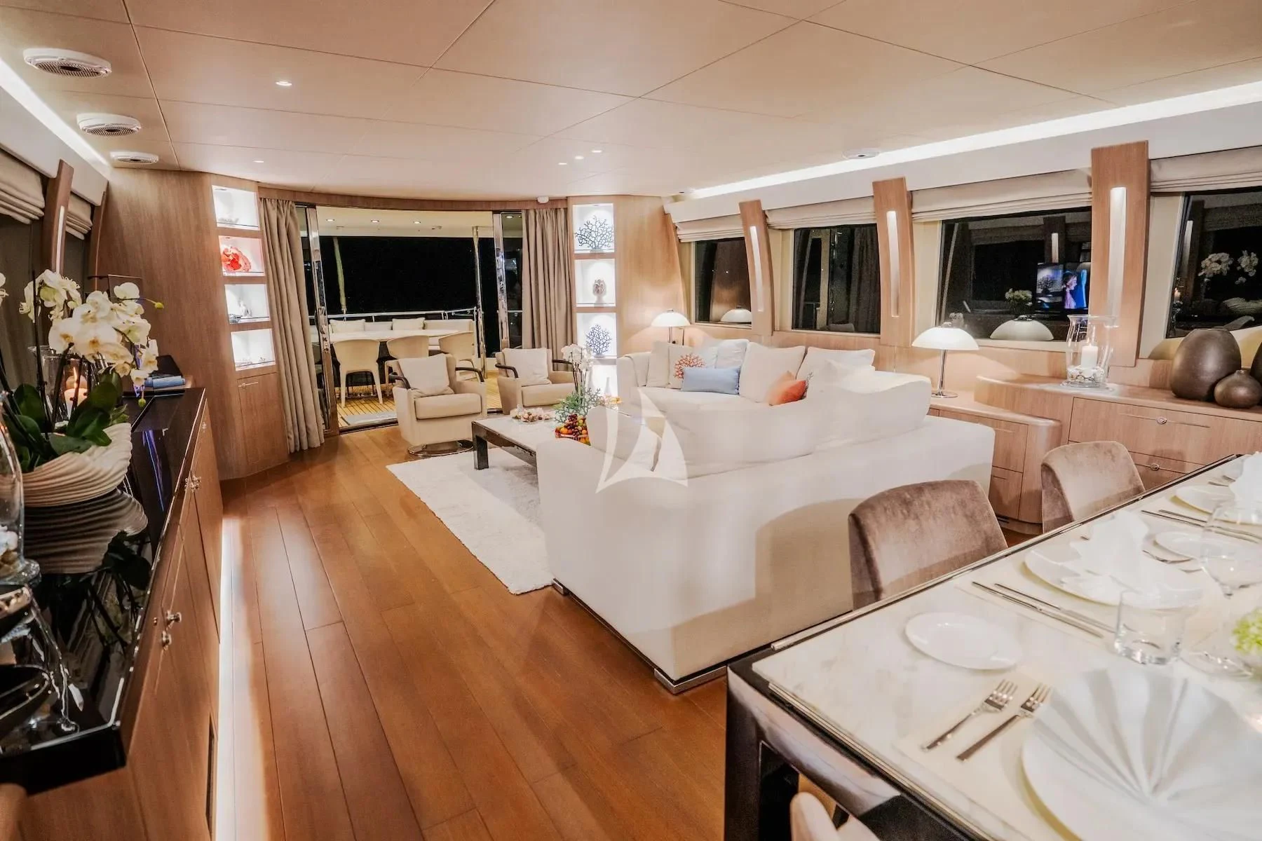 a living room with a large white couch and a table aboard CARPE DIEM Yacht for Sale